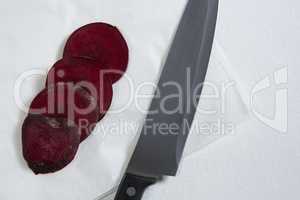 Sliced beetroots and knife on white background