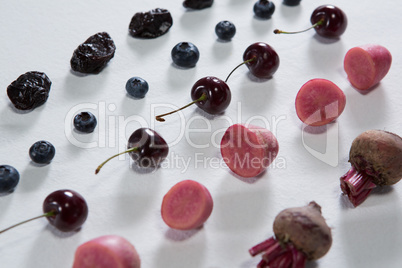 Fruits and vegetables arranged on white background