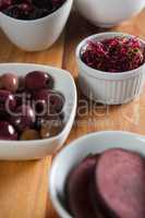 Close-up of beetroot slice with olives in bowls