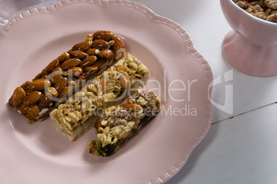 Granola bar in plate on white background
