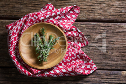 Fresh rosemary in wooden plate
