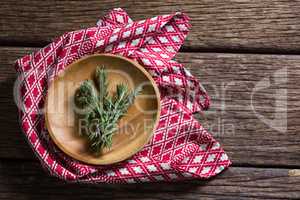 Fresh rosemary in wooden plate