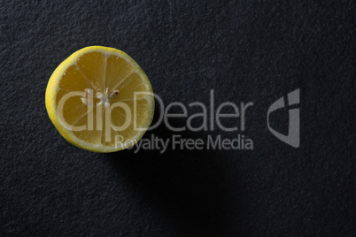 Halved lemon on black background