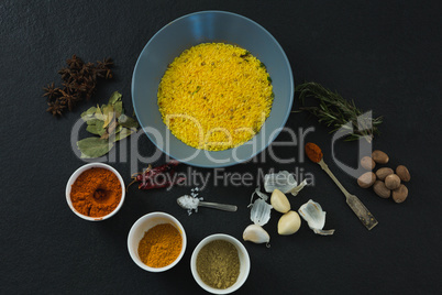 Rice in bowl with various spices and ingredients