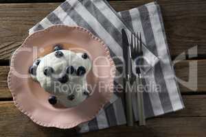Plate of breakfast with butter knife, fork and napkin