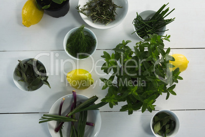 Various herbs in bowl with sweet lime