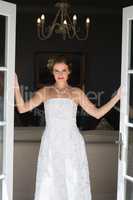 Portrait of beautiful bride standing at doorway