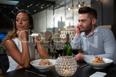 Woman ignoring man while dining