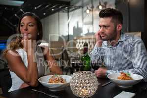 Woman ignoring man while dining