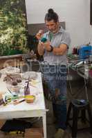 Attentive man painting bowl