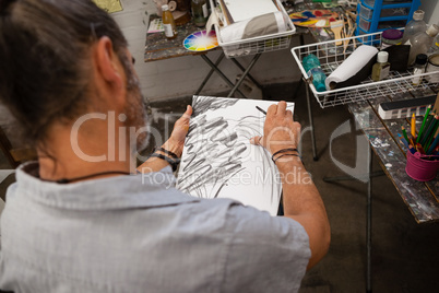 Man sketching in drawing book