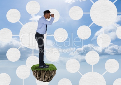 Businessman with binoculars on floating rock platform with interface mind maps in sky