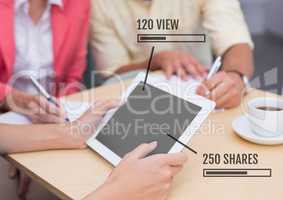 People on tablet with Views and Shares status bars at meeting