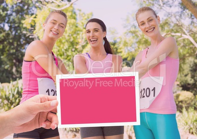 Hand holding card with pink breast cancer awareness women marathon run