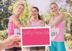 Hand holding card with pink breast cancer awareness women marathon run