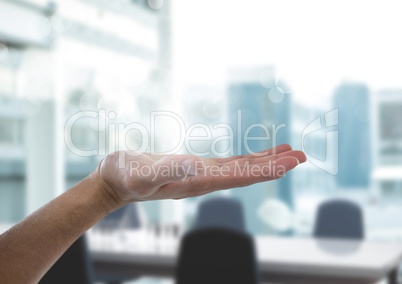 Open hand with bright office background