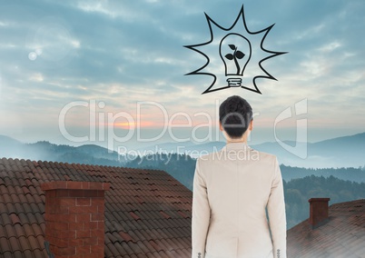 Light bulb and Businesswoman standing on Roofs with chimney and misty colorful landscape