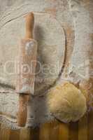 Overhead view of pastry dough with rolling pin