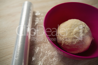 High angle view of kneaded dough in pink bowl