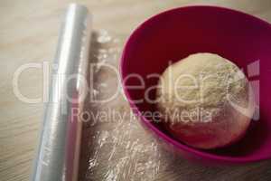 High angle view of kneaded dough in pink bowl