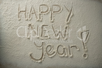 Overhead view of happy new year text on flour