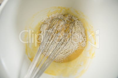 Close up of flour and egg batter in bowl