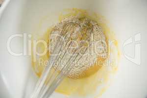 Close up of flour and egg batter in bowl