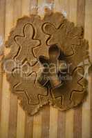 Close up of gingerbread man pastry cutter on dough