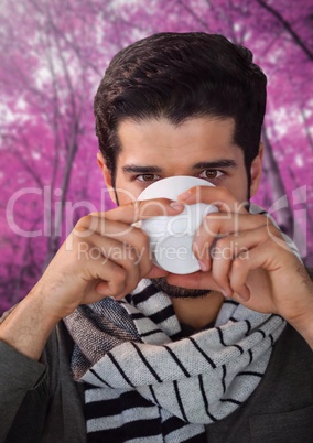 Man in Autumn with cup in forest