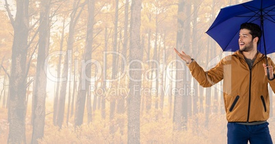 Man in Autumn with umbrella in bright forest