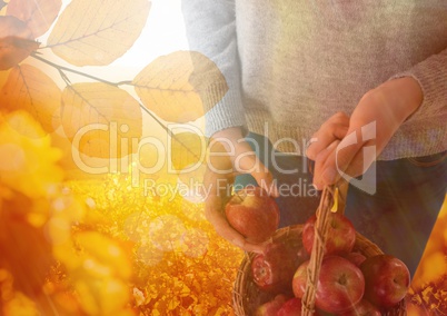 Woman in Autumn with basket of apples and leaves