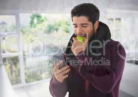 Man in Autumn with apple and phone at home