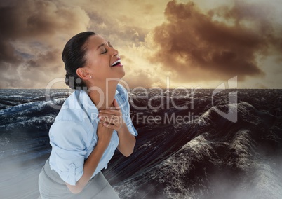 Businesswoman grieving in pain by ocean waves