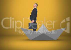 Businessman in paper boat in yellow room