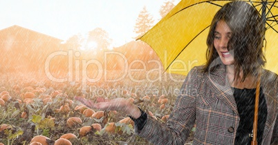 Woman in Autumn with apple in pumpkin field