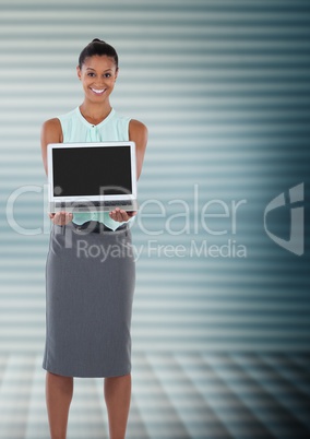 Businesswoman  holding laptop with ridges in background