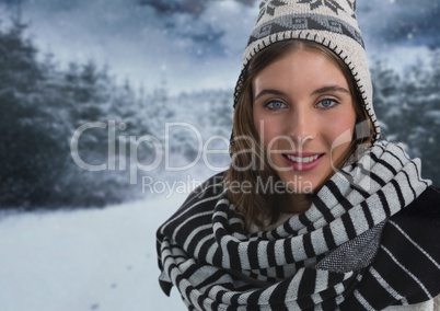Woman with scarf and hat in snow forest at night