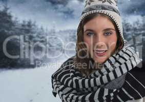 Woman with scarf and hat in snow forest at night