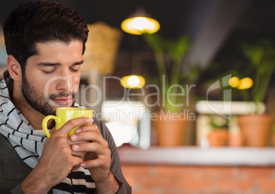 Man in Autumn with cup and scarf in cafe