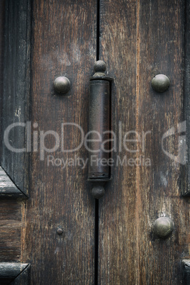 iron door hinge on old brown wooden doors