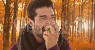 Man in Autumn eating apple in forest