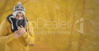 Man in Autumn with hat and scarf in yellow forest