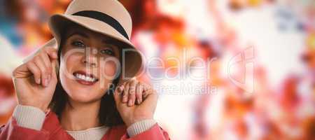 Composite image of close-up portrait of young woman in hat