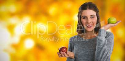 Composite image of portrait of young woman holding apples