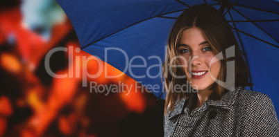 Composite image of portrait of woman with blue umbrella