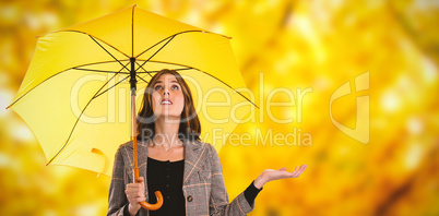 Composite image of full length of woman holding umbrella while gesturing
