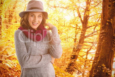 Composite image of portrait of smiling young woman in hat and scarf Composite image of portrait of smiling young woman in hat and scarf