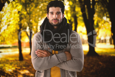 Composite image of portrait of man standing with arms crossed