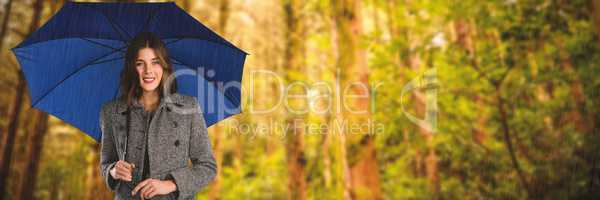 Composite image of portrait of young woman holding umbrella