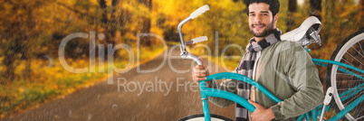 Composite image of portrait of smiling man carrying  bicycle
